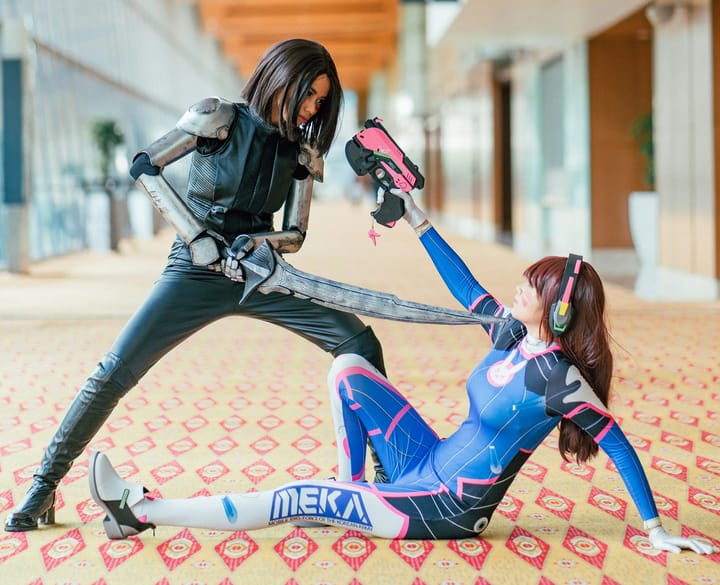 Two ladies posing in cosplay costumes